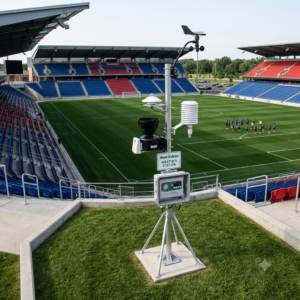 Weather station installed adjacent to a professional soccer stadium, monitoring solar radiation, temperature, humidity, wind speed, and rainfall to support real-time irrigation scheduling and evapotranspiration-based water management.